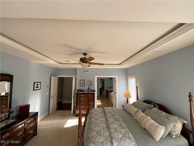 bedroom with light carpet, a raised ceiling, visible vents, and baseboards