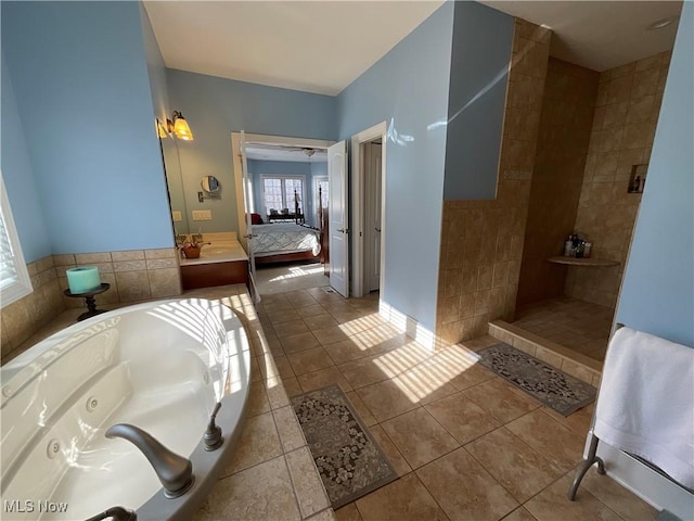 bathroom featuring ensuite bathroom, baseboards, tile patterned floors, a tub with jets, and walk in shower