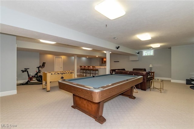 game room featuring light carpet, a textured ceiling, and baseboards