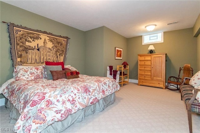 bedroom with visible vents and carpet flooring