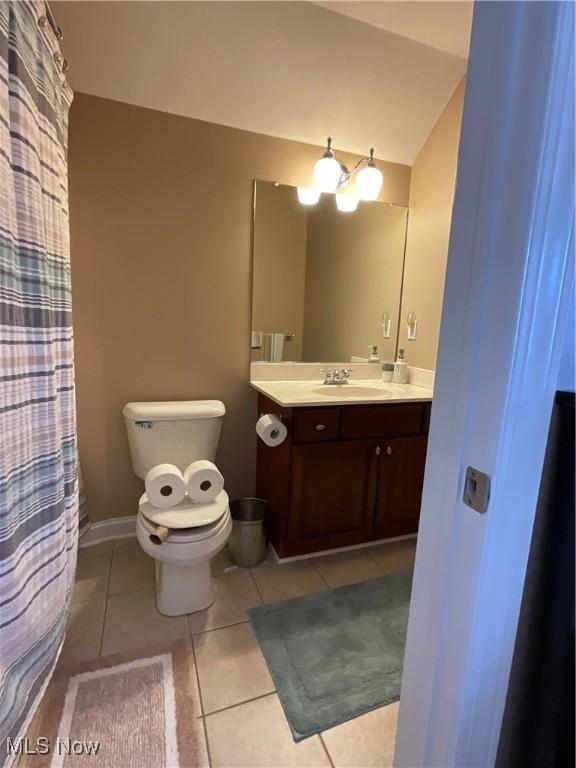 bathroom featuring toilet, tile patterned flooring, baseboards, and vanity