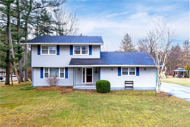 traditional home featuring a porch and a front lawn