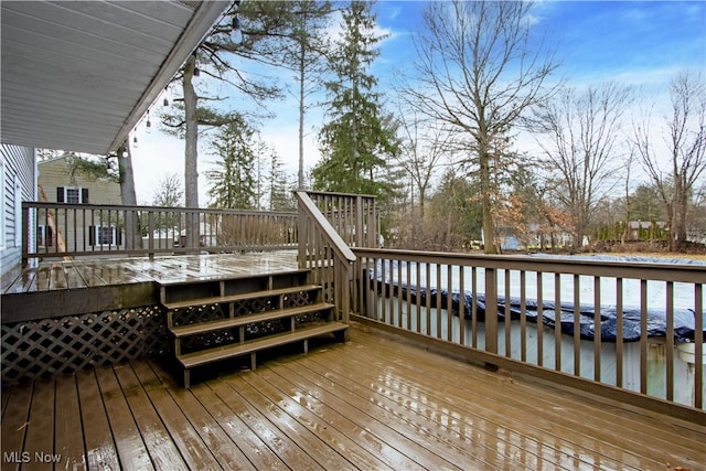 wooden terrace featuring a water view