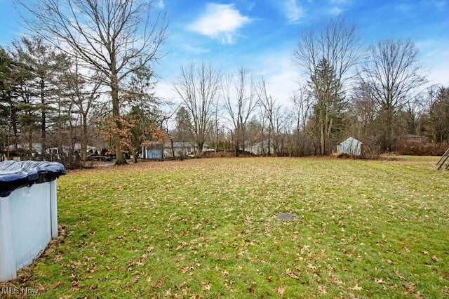 view of yard with a covered pool