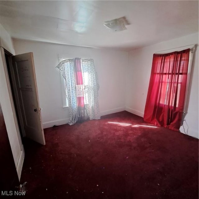 unfurnished room featuring baseboards and carpet floors