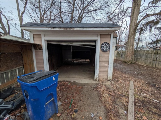 exterior space featuring a garage and fence