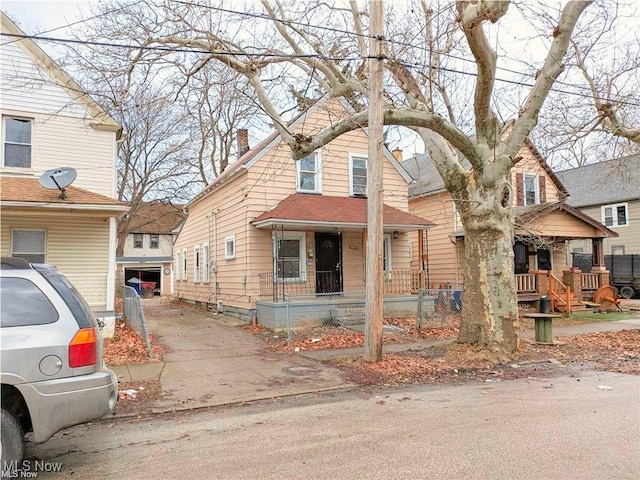 view of front of property featuring covered porch and a chimney