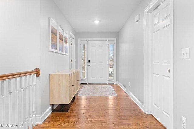 entrance foyer featuring light wood-style floors and baseboards