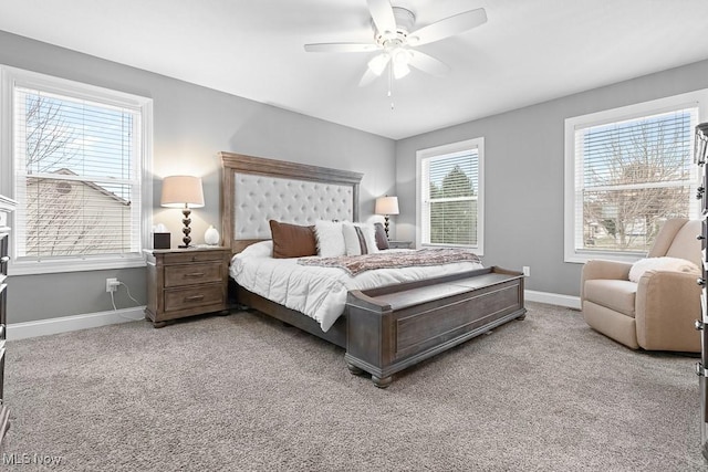 carpeted bedroom featuring baseboards and a ceiling fan