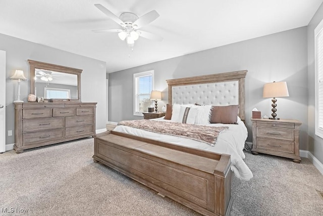 bedroom with ceiling fan, carpet flooring, and baseboards