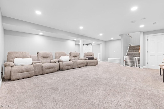 living area with carpet, recessed lighting, stairway, a barn door, and baseboards