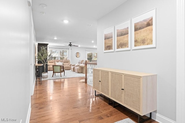 hallway with recessed lighting, baseboards, and hardwood / wood-style floors