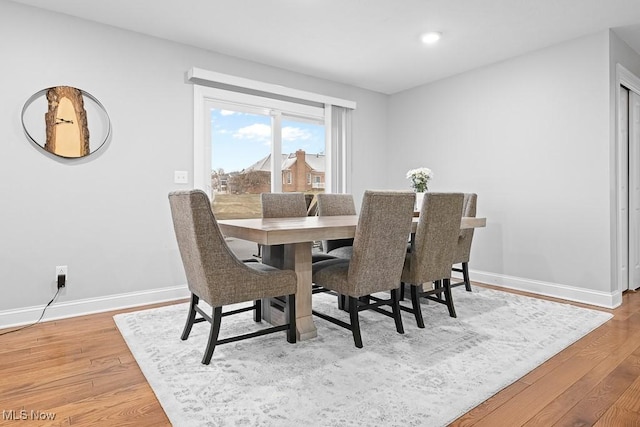 dining space featuring recessed lighting, baseboards, and light wood finished floors