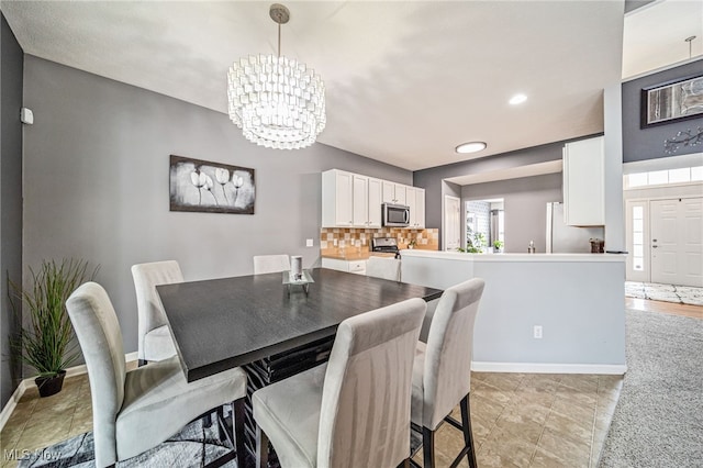 dining room featuring recessed lighting, baseboards, and an inviting chandelier