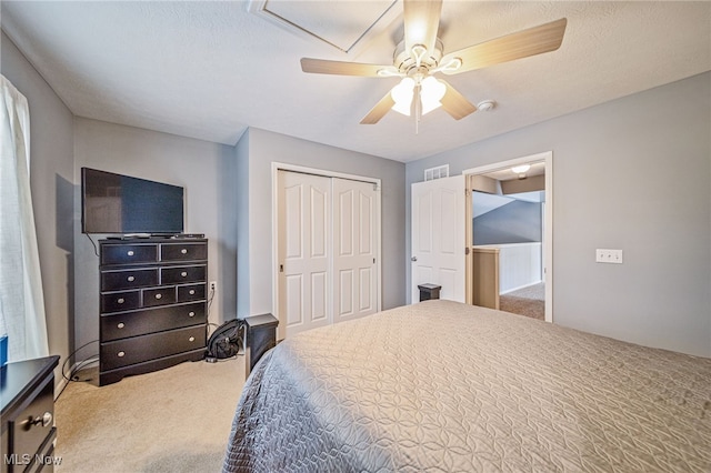 carpeted bedroom featuring a closet, visible vents, and a ceiling fan