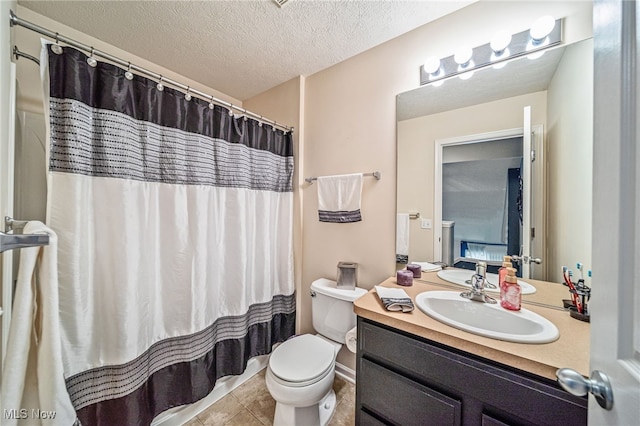 bathroom with a shower with curtain, toilet, a textured ceiling, vanity, and tile patterned flooring