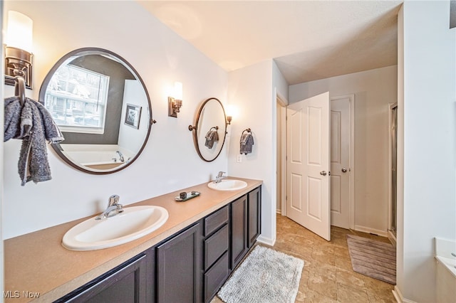 full bathroom featuring double vanity, a sink, and a bath