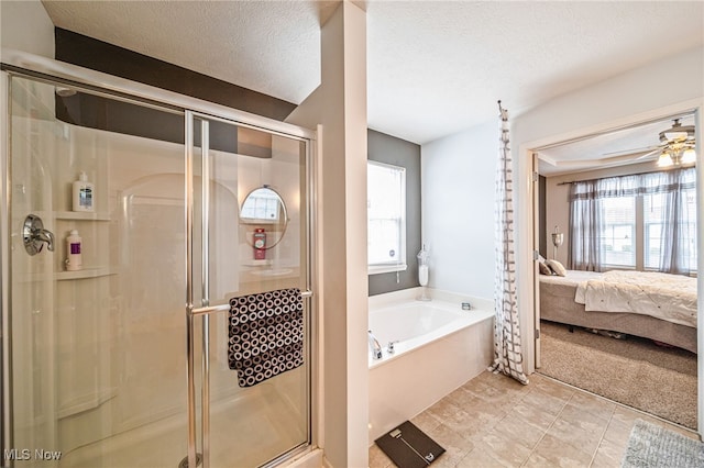 full bathroom with ensuite bathroom, ceiling fan, a shower stall, a textured ceiling, and a bath