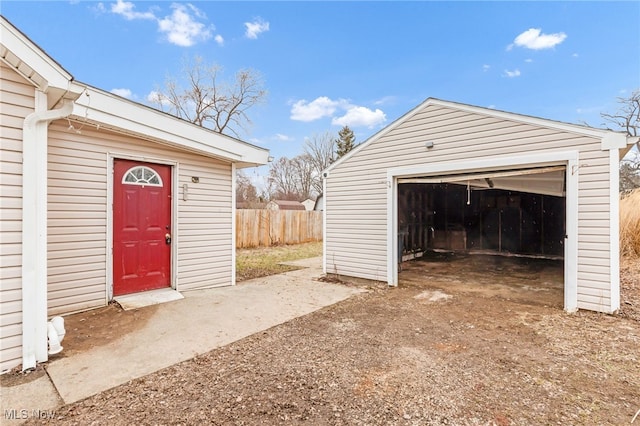 detached garage featuring fence