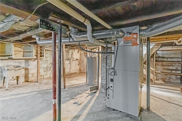 unfinished below grade area featuring water heater and a sink