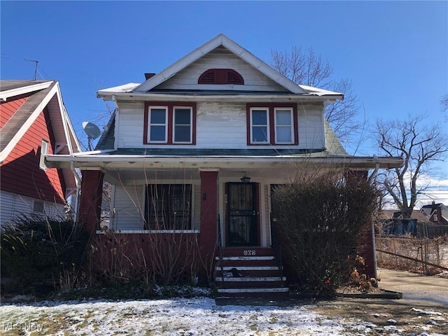 american foursquare style home with a porch