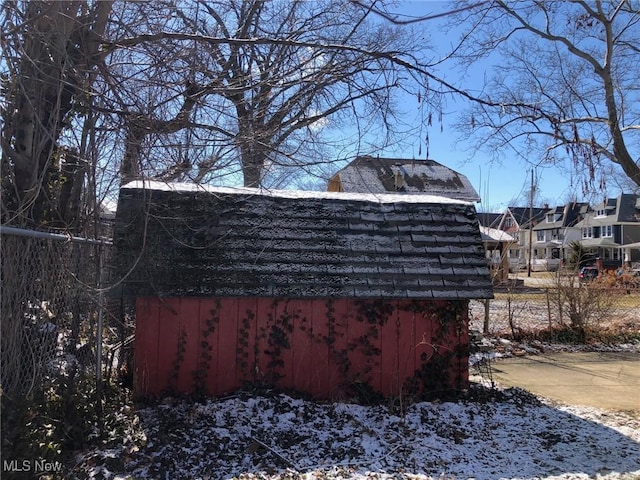 view of snow covered exterior with an outbuilding