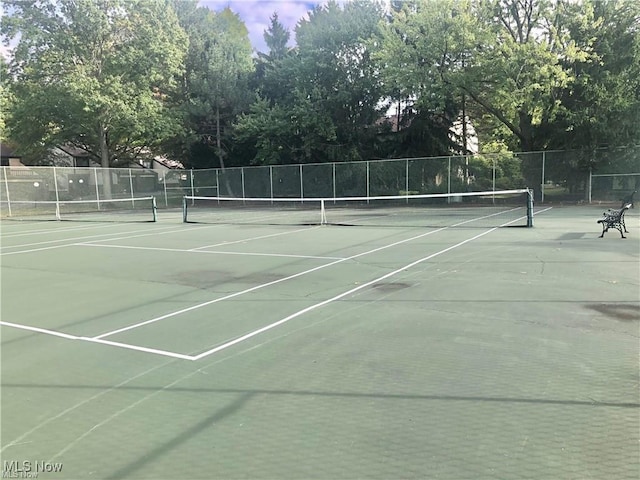 view of tennis court featuring fence