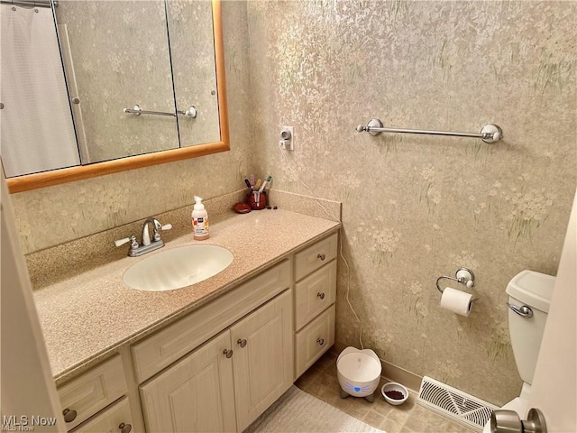 full bathroom with toilet, tile patterned flooring, vanity, and visible vents