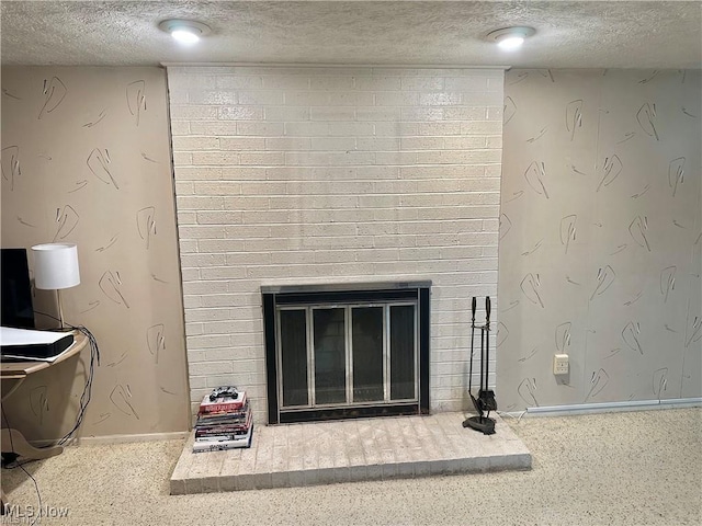 room details featuring a fireplace, a textured ceiling, baseboards, and speckled floor