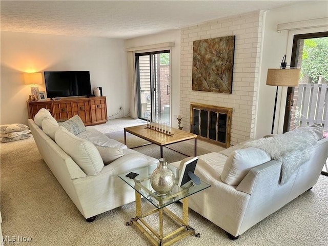 carpeted living area featuring a brick fireplace