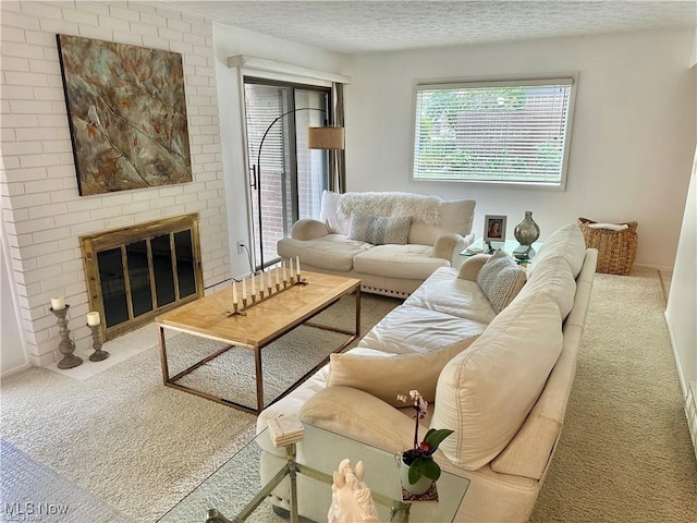 living room featuring a textured ceiling, a fireplace, and carpet