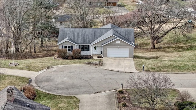 view of front of property with a front yard, an attached garage, driveway, and roof with shingles