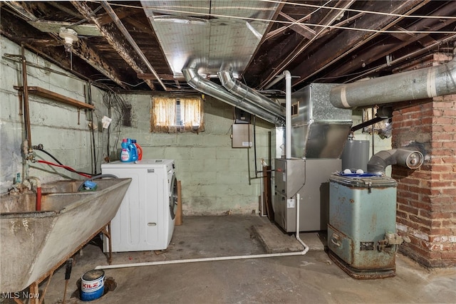 below grade area with heating unit, gas water heater, washer / clothes dryer, and a sink