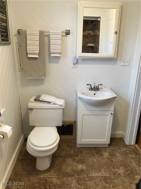 bathroom with visible vents, vanity, and toilet