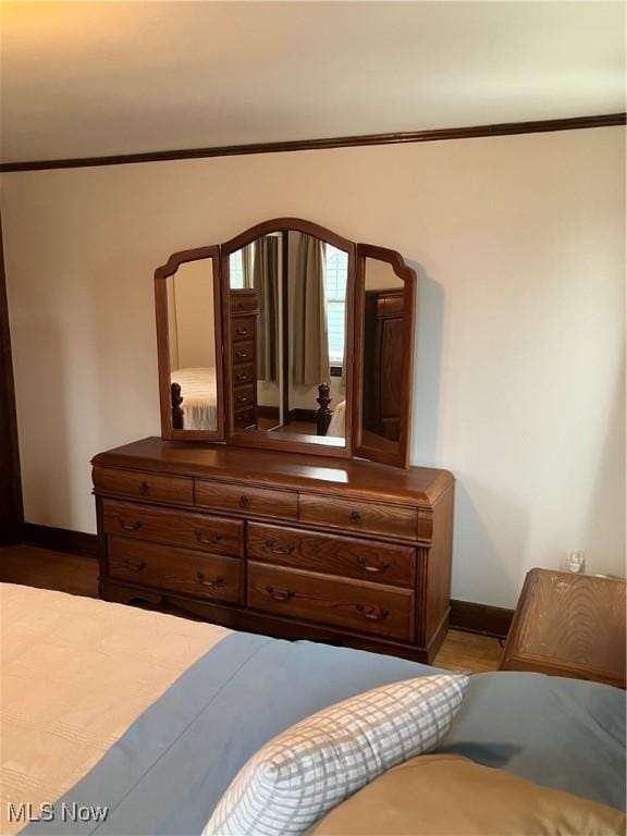 bedroom featuring ornamental molding and baseboards