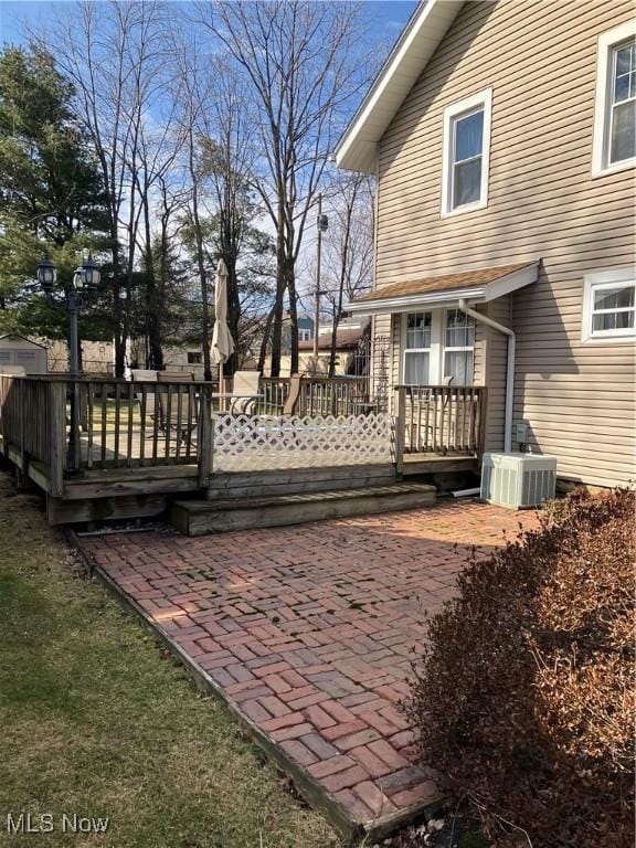 exterior space with a deck, central AC, and a patio area