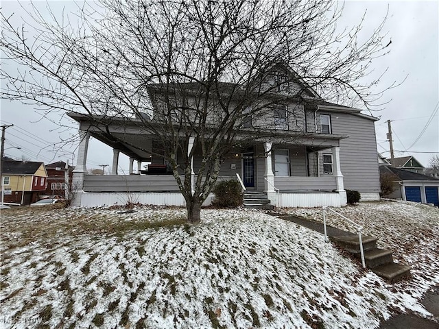 view of front of house with a porch and an outdoor structure