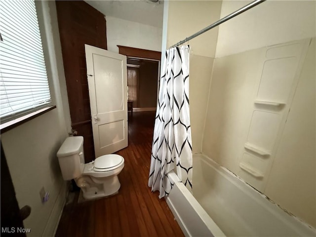 bathroom featuring shower / bath combo with shower curtain, toilet, and wood finished floors