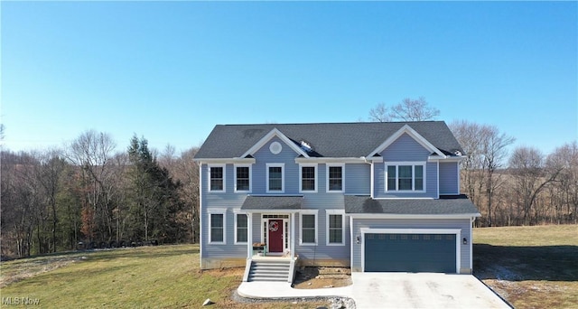 view of front of property featuring driveway, an attached garage, and a front yard