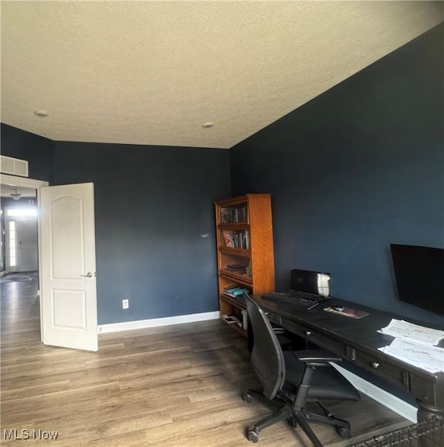 office area featuring a textured ceiling, wood finished floors, and baseboards