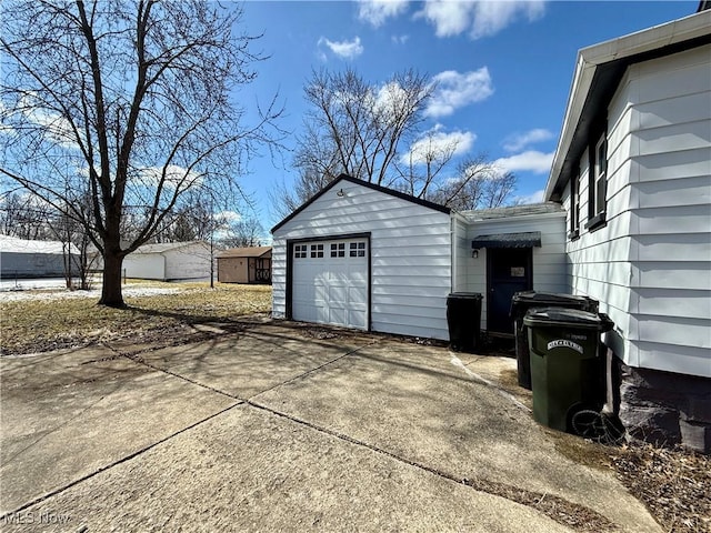 garage featuring concrete driveway