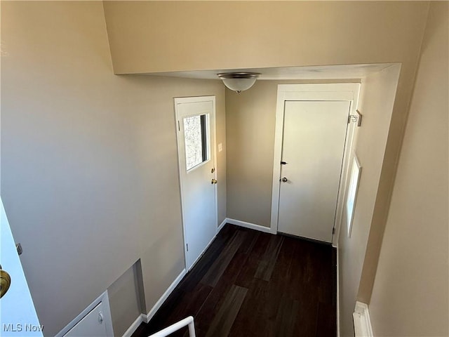 doorway to outside with baseboards and dark wood finished floors