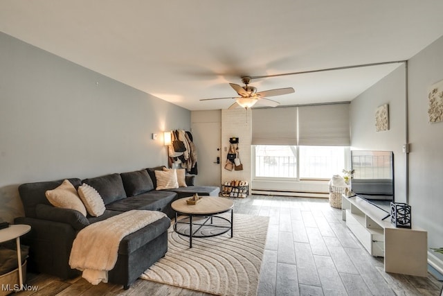 living room with a ceiling fan, a baseboard radiator, and wood finished floors