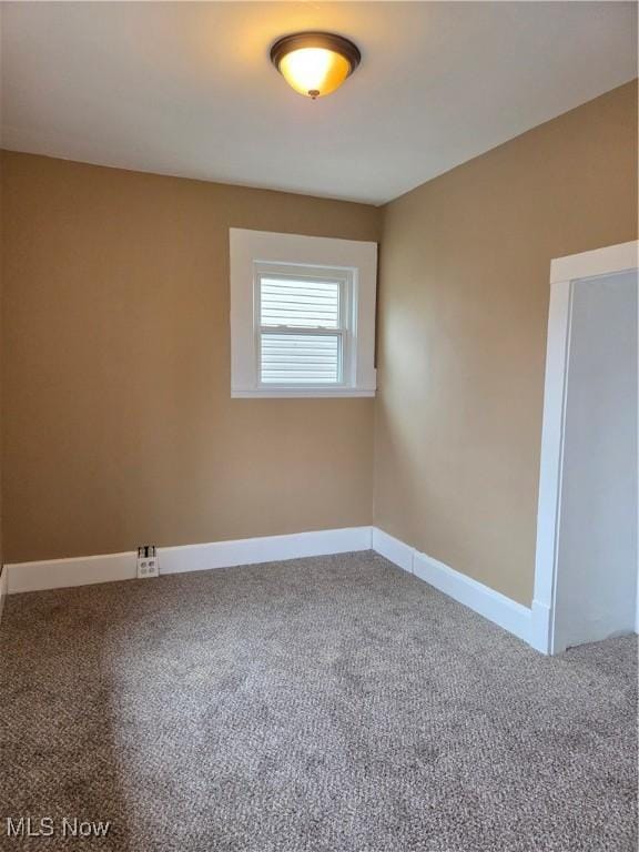 carpeted spare room with baseboards