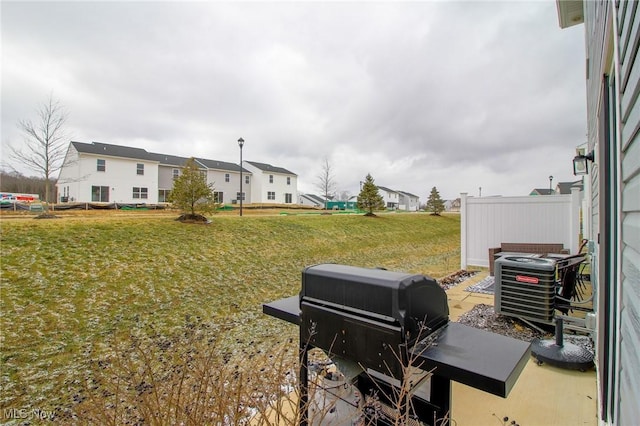 view of yard featuring cooling unit and a residential view