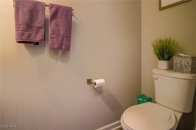 bathroom with toilet and baseboards