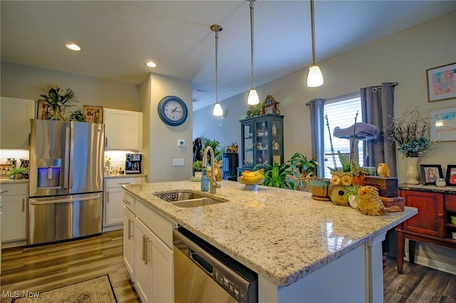 kitchen with appliances with stainless steel finishes, white cabinetry, a sink, and dark wood-type flooring