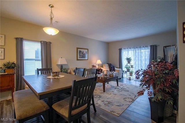 dining space with wood finished floors