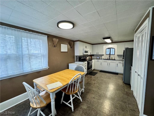 dining room featuring a wealth of natural light and baseboards