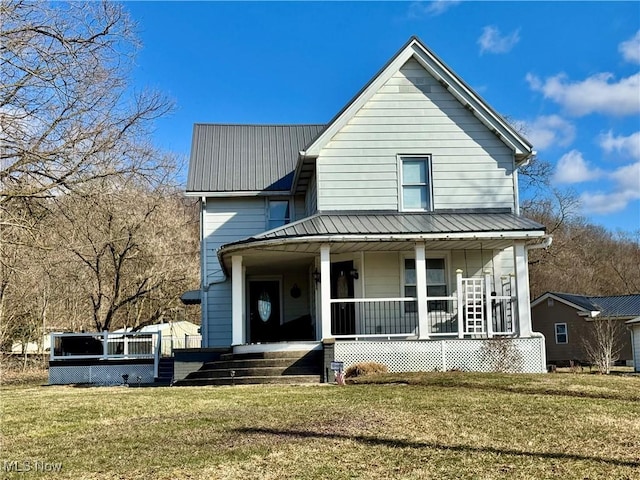 view of front of property with metal roof, a porch, and a front yard